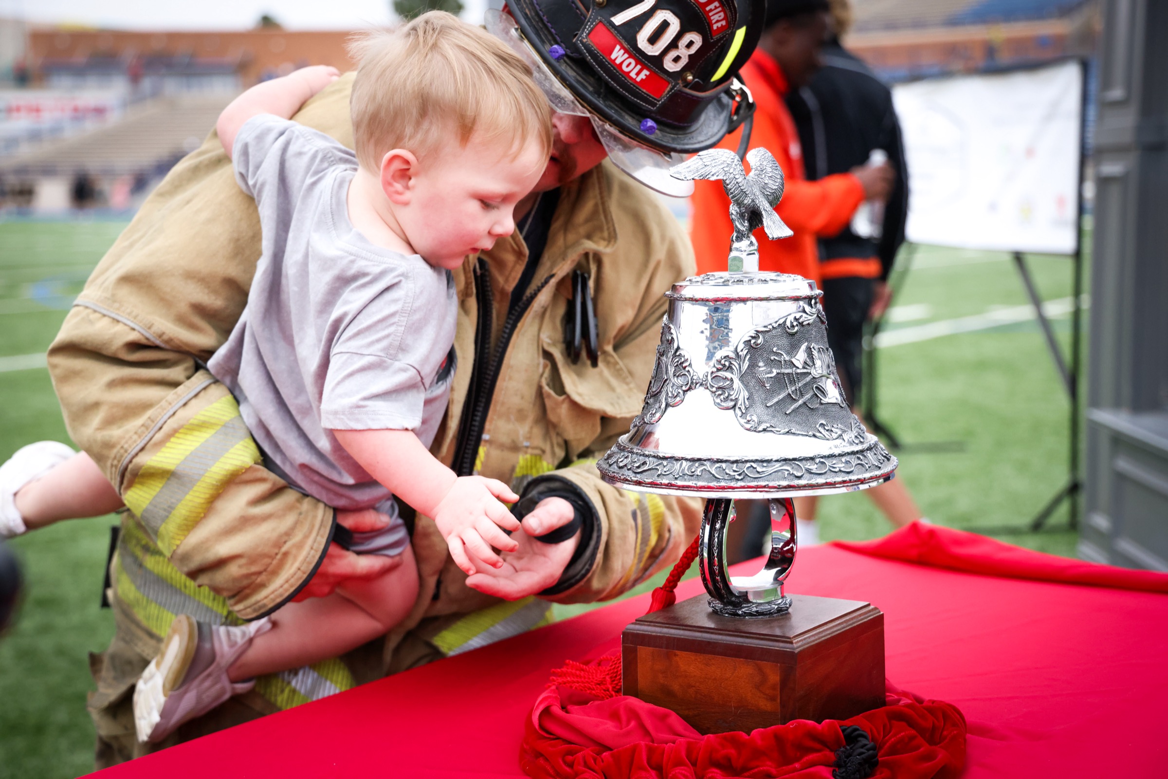 A Midland firefighter climbing stadium stairs in full turnout gear